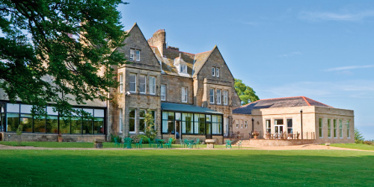 Grinkle Park house featuring a sprawling lawn