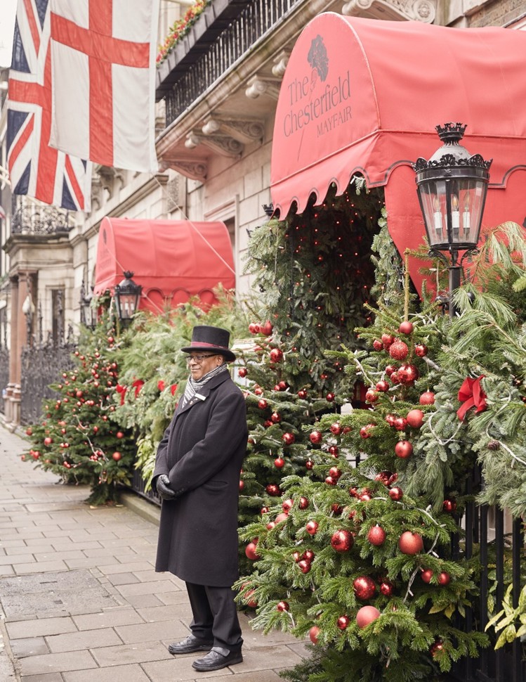 The Chesterfield Mayfair Exterior - Lush Christmas Greenery, Red Baubles, Garlands, and a Porter